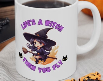 May include: White ceramic mug with a Halloween theme. The mug features a cartoon witch graphic and the text "Life's a Witch Then You Fly" in purple. Black cat graphics are on either side of the witch. The mug is surrounded by Halloween candy and a pumpkin.