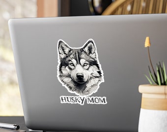 May include: A black and white illustration of a husky dog's face with the text "Husky Mom" below it. The image is on a silver laptop.