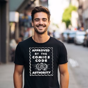May include: A black t-shirt with a white graphic of a stamp that says "Approved by the Comics Code Authority".