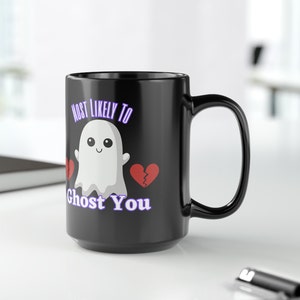 May include: Black coffee mug with a white ghost illustration and the text "Most Likely To Ghost You".