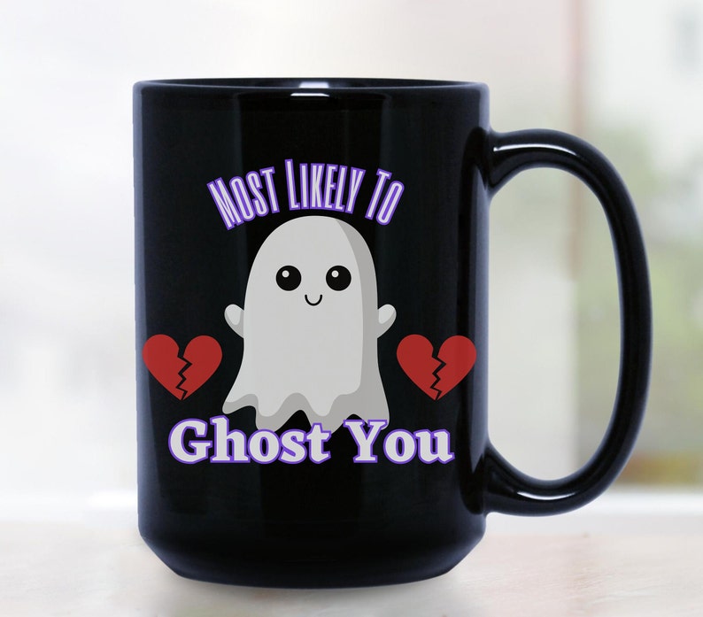 May include: Black coffee mug with a white ghost and two broken red hearts. The text "Most Likely To Ghost You" is printed in purple on the mug.