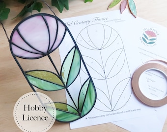 May include: A stained glass flower pattern featuring a pink flower and green leaves. The pattern is printed on white paper with the title "Mid Century Flower" and instructions for creating the stained glass project. The pattern is for hobby use only and may not be distributed or sold.
