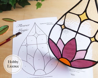 May include: A stained glass flower pattern with numbered sections, a hobby licence, and the text "Flower Magic" and "A pattern by Wild Snail Stained Glass".