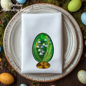 May include: White linen napkin with a green and white embroidered Easter egg design. The egg is decorated with lily of the valley flowers.