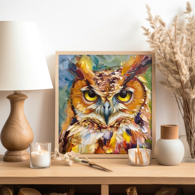 May include: A framed painting of an owl with yellow eyes, brown and orange feathers, and a detailed, textured style. The owl is looking directly at the viewer.