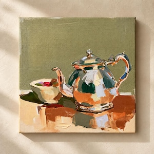 Puede incluir: Una pintura al óleo sobre lienzo que representa una tetera metálica y un pequeño cuenco lleno de objetos coloridos. La tetera presenta reflejos en tonos naranja, blanco y verde oscuro, sobre un fondo verde oliva apagado.