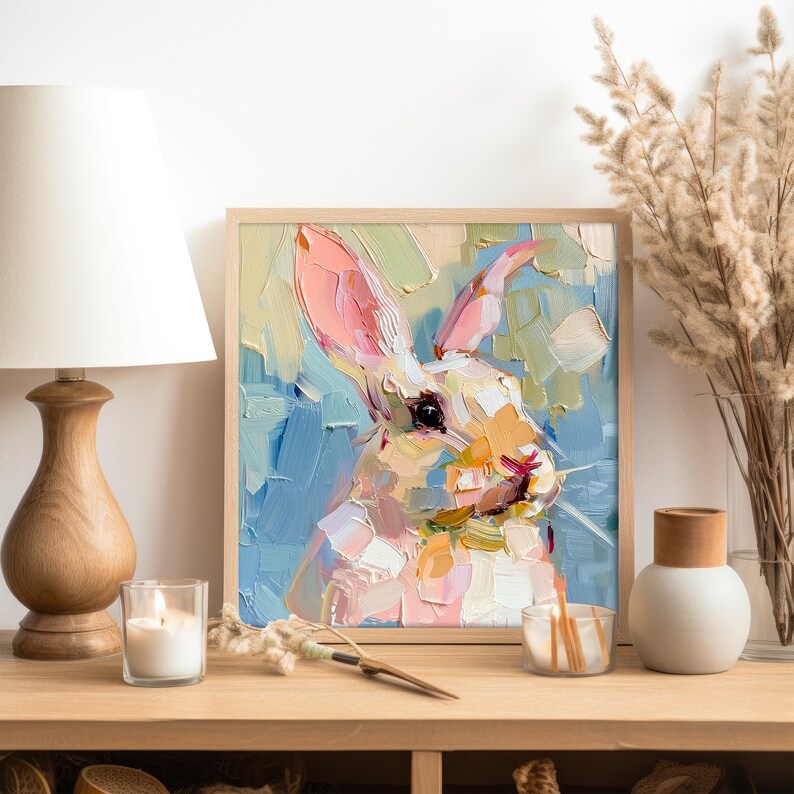 May include: A painting of a white rabbit with pink ears, painted in a colorful, impressionistic style. The rabbit's face is close-up and the background is a blur of blue, green, and yellow.