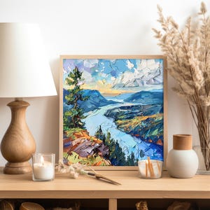 May include: A framed painting of a landscape with a river winding through a valley. The painting is done in a palette of blues, greens, and browns, with a touch of orange in the sky. The river is a bright blue, and the valley is a mix of green and brown.