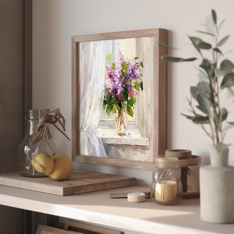 May include: A framed painting of a bouquet of purple lilacs in a vase on a windowsill. The window is open and there is a white curtain blowing in the breeze. The painting is done in a realistic style with soft colors.