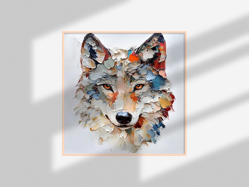 May include: A square framed painting of a wolf's head. The artwork uses a textured, impasto style with visible brushstrokes. The wolf's fur is rendered in shades of white, gray, orange, blue, and red. The wolf has orange eyes and a black nose.
