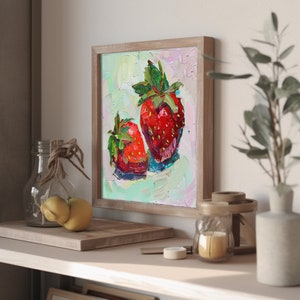 May include: A framed painting of two red strawberries on a light green background. The strawberries are painted in a loose, impressionistic style with visible brushstrokes.