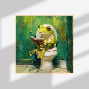 以下が含まれることがあります： 白いトイレで本を読む緑色のカエルの額入り絵画。カエルは黄色の足とオレンジ色の目をしています。背景はテクスチャ加工された緑色で、絵画は気まぐれな芸術的スタイルです。