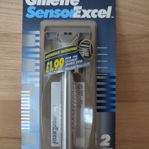 May include: A silver Gillette SensorExcel razor with a blue and white label. The label says "Experience Microfins" and "For the closest shave ever". The price is $1.99.