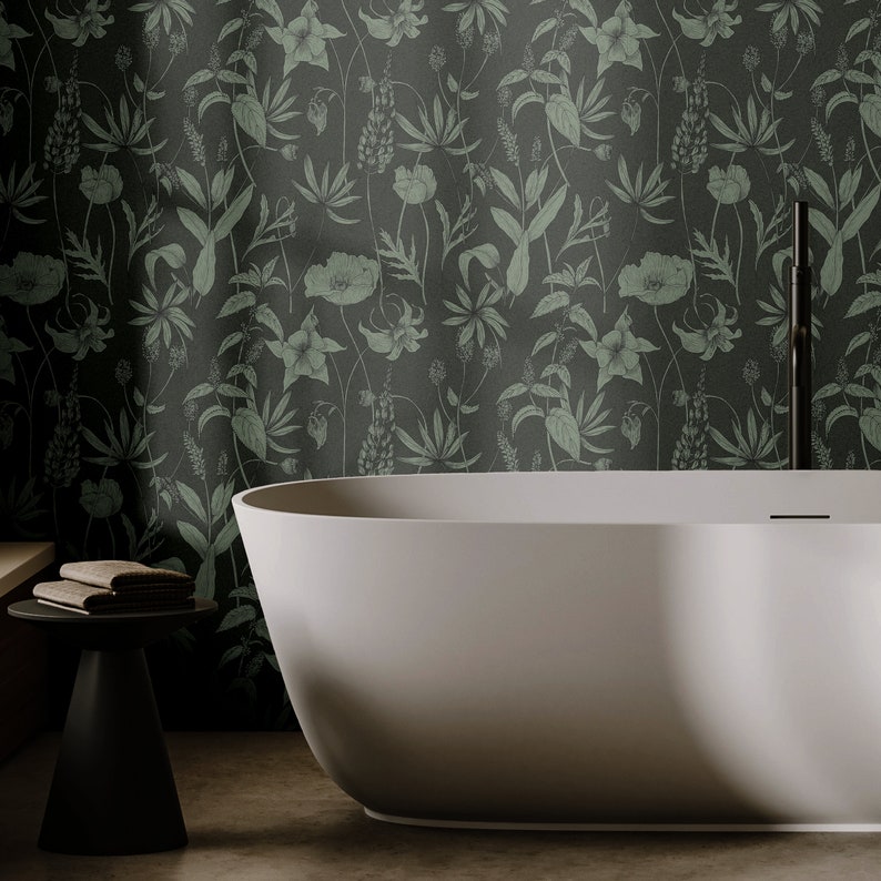 May include: A white freestanding bath with a floral patterned wallpaper backdrop. The wallpaper features a repeating pattern of green leaves and flowers.