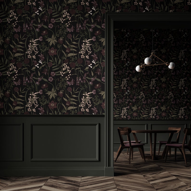 May include: A dark green dining room with a floral wallpaper, a wooden table with four chairs, and a modern light fixture with three white globes.