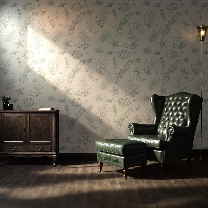 May include: A living room with a green leather armchair and ottoman in front of a wall with a light green and white wallpaper featuring a repeating pattern of sea creatures, including squid, seahorses, and starfish.