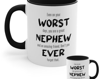 May include: White ceramic mug with a black interior and handle. The mug features the text "Even on your WORST days, you are a great NEPHEW and an amazing friend. Don't you EVER forget that." A smaller version of the mug is also visible.