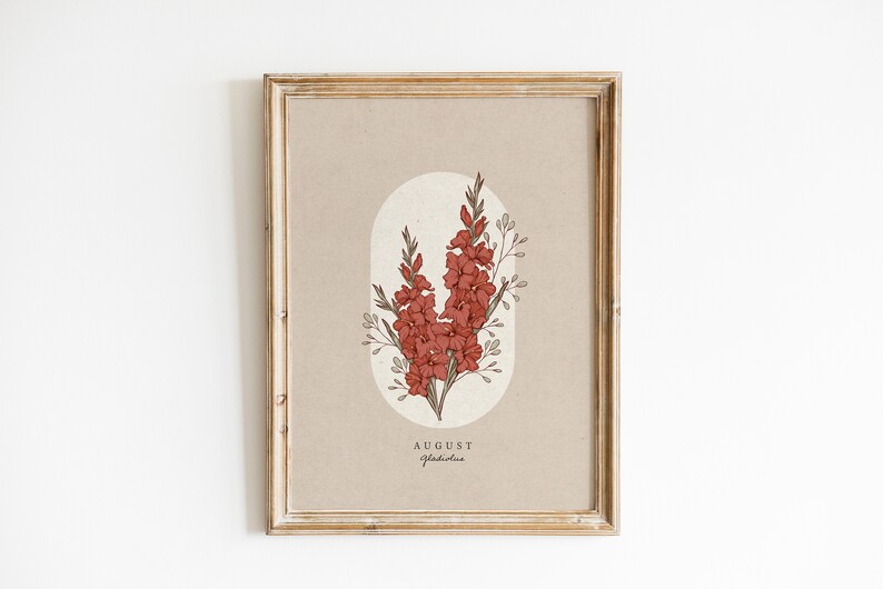 May include: A framed print with a beige background featuring a botanical illustration of a red gladiolus flower with the text "AUGUST Gladiolus" at the bottom.