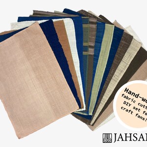 May include: Assortment of hand-woven fabric cuttings in various colors and textures, including beige, brown, blue, and green. The fabric pieces are arranged in a fan shape. The text "Hand-woven fabric cuttings DIY set for craft fans!" is visible in a circle on the right side of the image. The text "JAH SANG" is visible in the bottom right corner of the image.