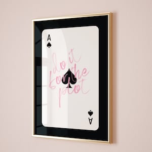 May include: A framed print of an ace of spades playing card with the text "do it for the plot" written in pink script.