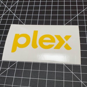 May include: A white sticker with the word "plex" in yellow letters.