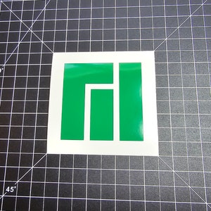 May include: Green and white sticker with the logo of the programming language Rust. The logo is a stylized 'R' with a square shape.