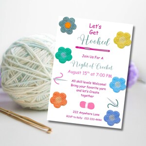 May include: A white invitation card with the text "Let's Get Hooked" and "Night of Crochet". The card is decorated with crochet flowers in various colors and a ball of yarn. A crochet hook is in the foreground.