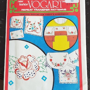 May include: A vintage embroidery transfer pattern sheet with the title "VOGART" and the text "REPEAT TRANSFER PATTERNS" and "GRACEFUL DESIGNS FOR TODAY'S HOMEMAKER". The sheet features several floral designs, including a rose, a bouquet of flowers, and a floral border.