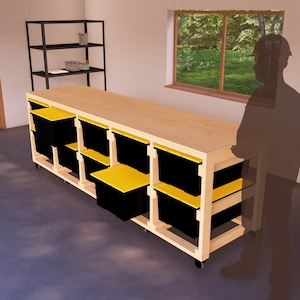 Peut inclure: Un établi en bois avec un plateau en bois clair et des bacs de rangement noirs. L'établi est sur roulettes et possède une étagère en dessous. L'établi se trouve dans un garage avec une fenêtre en arrière-plan.