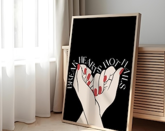 May include: A framed art print featuring a black background with the text "Break Hearts Not Nails." The artwork depicts two hands clasped together, with red nail polish. The frame is a light wood color.