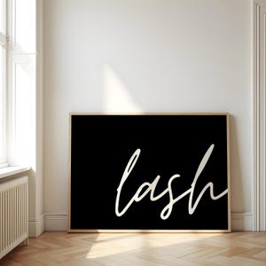 Puede incluir: Una impresión en blanco y negro con la palabra "lash" escrita en cursiva sobre un fondo negro.