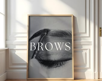 May include: A black and white photo of an eye with a brow being shaped with a brush. The word "BROWS" is printed in white letters in the center of the image.