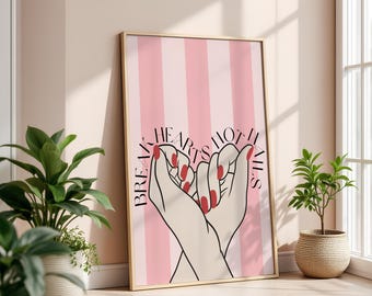 May include: A framed art print featuring a pink and white striped background. The artwork depicts two hands forming a heart shape, with red nail polish. The text reads "Break Hearts Not Nails."