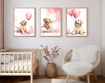 May include: Three watercolour paintings of golden retriever puppies playing with pink balloons. The paintings are framed and hung on a white wall.