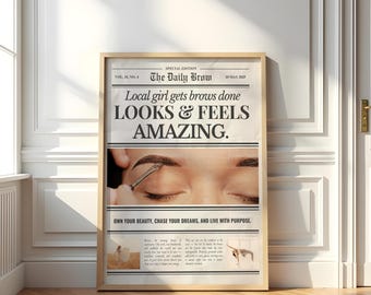 May include: A framed newspaper-style print with the headline "The Daily Brow." The text reads "Local girl gets brows done LOOKS & FEELS AMAZING." The image shows a close-up of an eyebrow being groomed. The bottom text says "OWN YOUR BEAUTY, CHASE YOUR DREAMS, AND LIVE WITH PURPOSE."