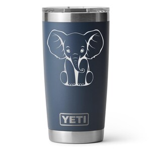 A navy 20oz Yeti Rambler Tumbler laser etched with a sitting elephant. The tumbler is a play on a white elephant gift.
