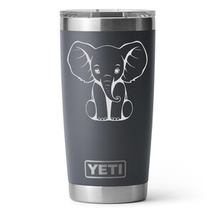 A charcoal 20oz Yeti Rambler Tumbler laser etched with a sitting elephant. The tumbler is a play on a white elephant gift.