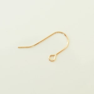 May include: Gold-toned earring hook with a small loop at the end.
