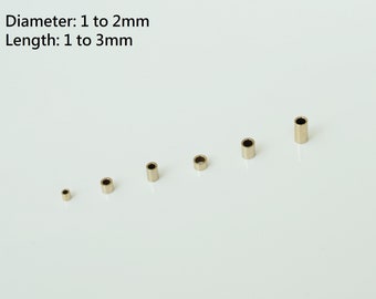 May include: A set of six gold-colored metal tubes of varying lengths and diameters. The tubes are arranged in a row from smallest to largest. The text "Diameter: 1 to 2mm Length: 1 to 3mm" is visible above the tubes.