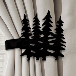 May include: Black metal curtain tieback shaped like a group of five pine trees.