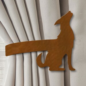 May include: A brown metal coyote silhouette curtain tieback. The coyote is howling and has a long tail.