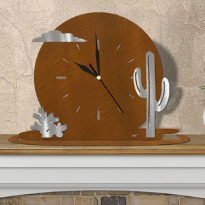 May include: A decorative metal clock with a desert theme. The clock face is a rusty brown color, with silver-colored accents including a cloud, cactus, and hands. The clock is displayed on a wooden shelf with a small potted plant.