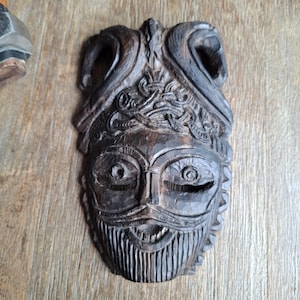 Hand carved viking god Odin&#39;s mask inspired by Oseberg Viking ship burial carvings . Hand carved in exotic ebony hardwood . With runes