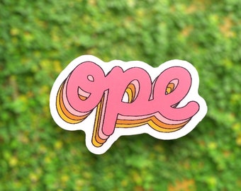 May include: A pink and orange sticker with the word "ope" written in a retro, wavy font.