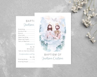 May include: Baptism invitation with a watercolour illustration of two figures in water, and a dove above. The text "Baptism of Jackson Carlson" is displayed in a soft blue font. A coordinating program card is also shown.