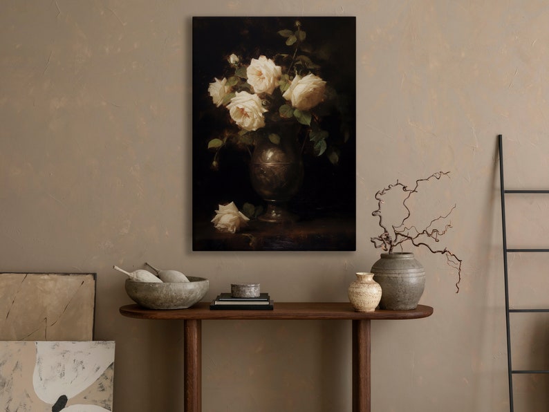 May include: A painting of a bouquet of white roses in a silver vase. The roses are arranged in a loose, natural style, and the vase is decorated with a simple design. The background is a dark, muted color.