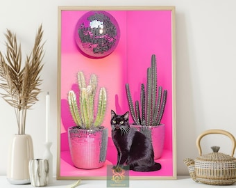 May include: A framed print featuring a black cat, cacti, and a disco ball against a vibrant pink backdrop. The cacti are in pink mosaic pots. A decorative vase, candle, and teapot are in the foreground.