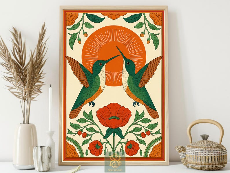May include: Framed art print featuring two green and brown hummingbirds facing each other, with a large orange sun in the background. The artwork includes red flowers and green foliage, all within a decorative border.