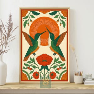 May include: Framed art print featuring two hummingbirds facing each other, with a vibrant orange sun in the background. The birds are green and orange, set against a cream-colored backdrop with floral accents in red and green.