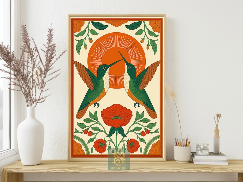 May include: Framed art print featuring two hummingbirds facing each other, with a vibrant orange sun in the background. The birds are green and orange, set against a cream-colored backdrop with floral accents in red and green.